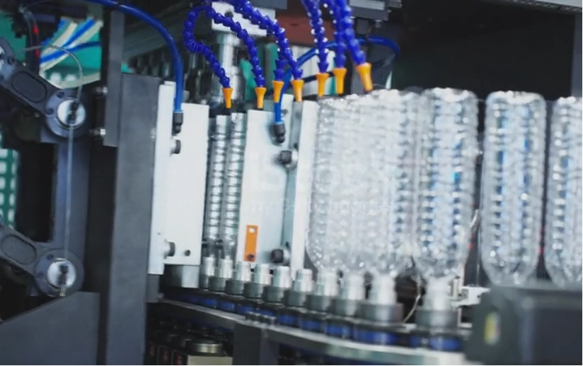 blowing machine of plastic bottle moving to filling process in bottling plant at beverage factory
