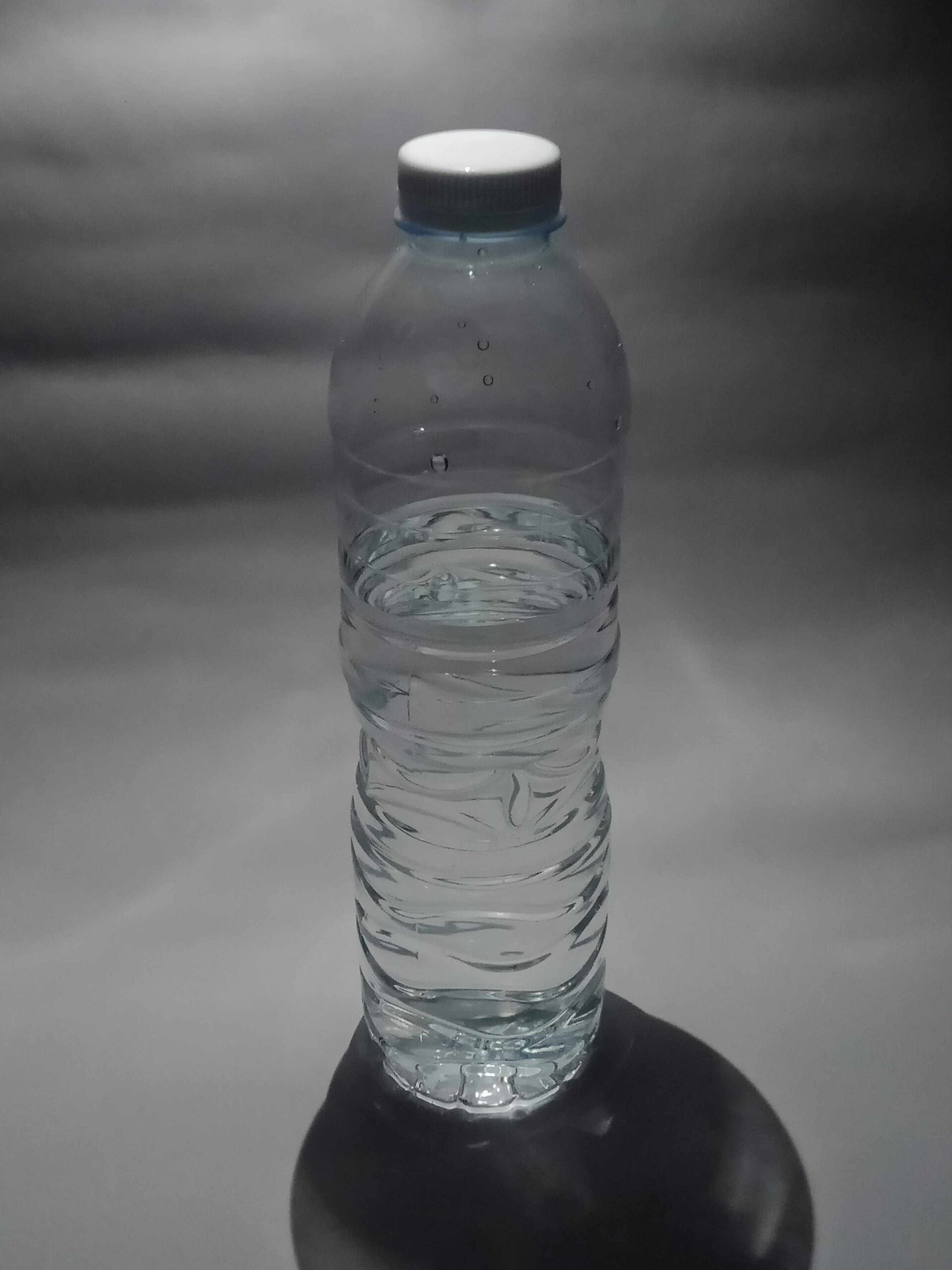 clear-pet-beverage-bottle-on-plain-background